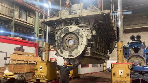 Large industrial engine being hoisted